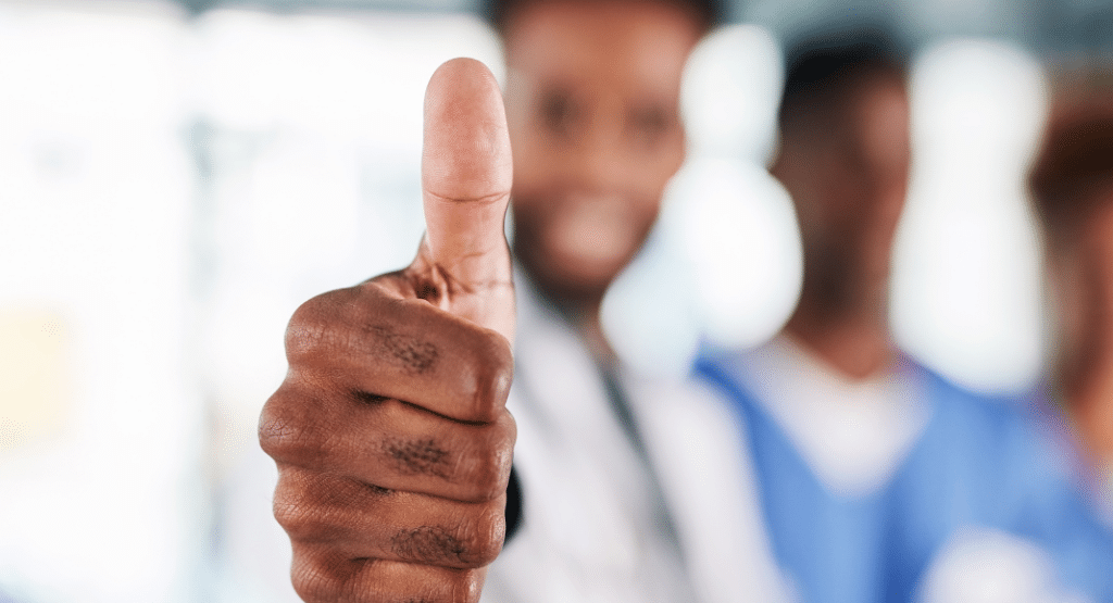 An Image of a man with thumbs up depicting employee satisfaction