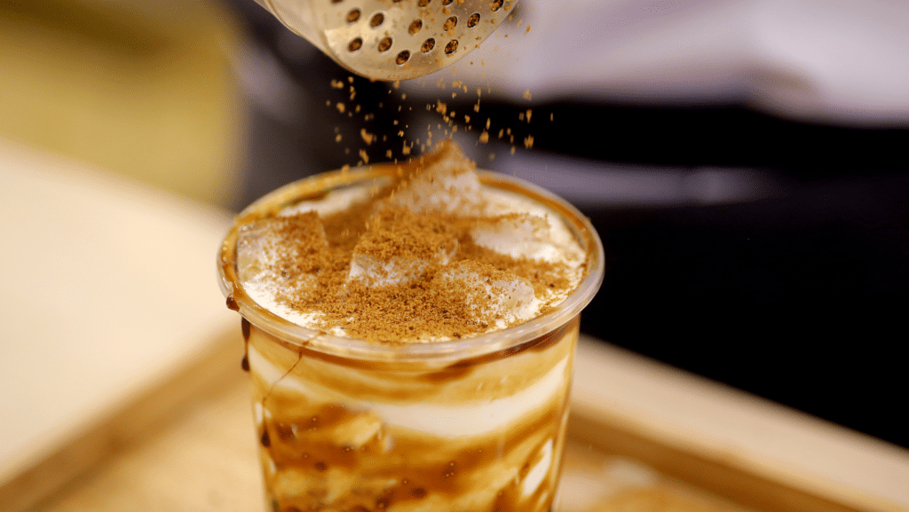 An Image of Flavoured Powder Being Added to A Bubble Tea