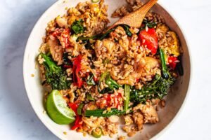 A delicious and healthy meal featuring konjac rice recipes - stir-fried rice with chicken, vegetables, and egg.