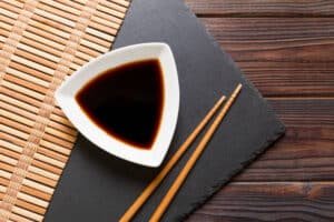 Konjac soy sauce in a dish with bamboo chopstick on a wooden surface