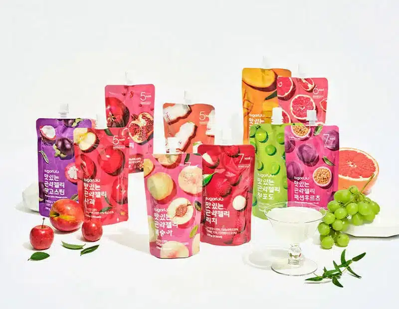 Pouches of Korean konjac jelly displayed with fresh fruit