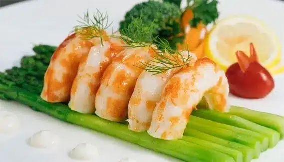 A dish of konjac shrimp on asparagus leaves